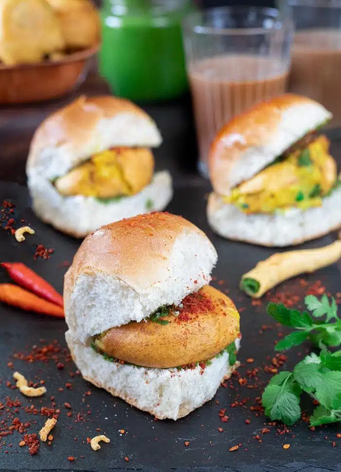 Vadas topped with garlic chutney in a pav