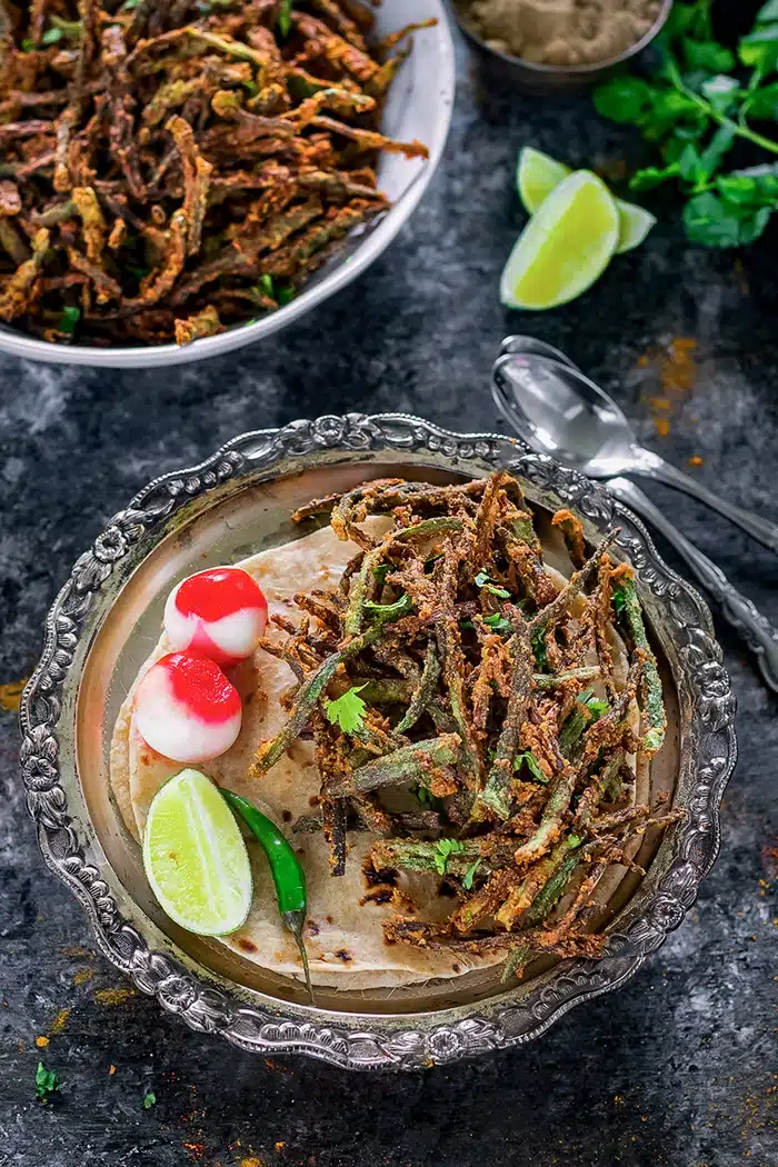 Kurkuri bhindi on a plate with vinegar onions