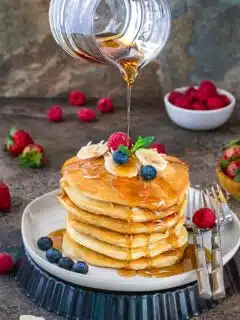 Vegan Coconut Banana pancakes drizzled with maple syrup