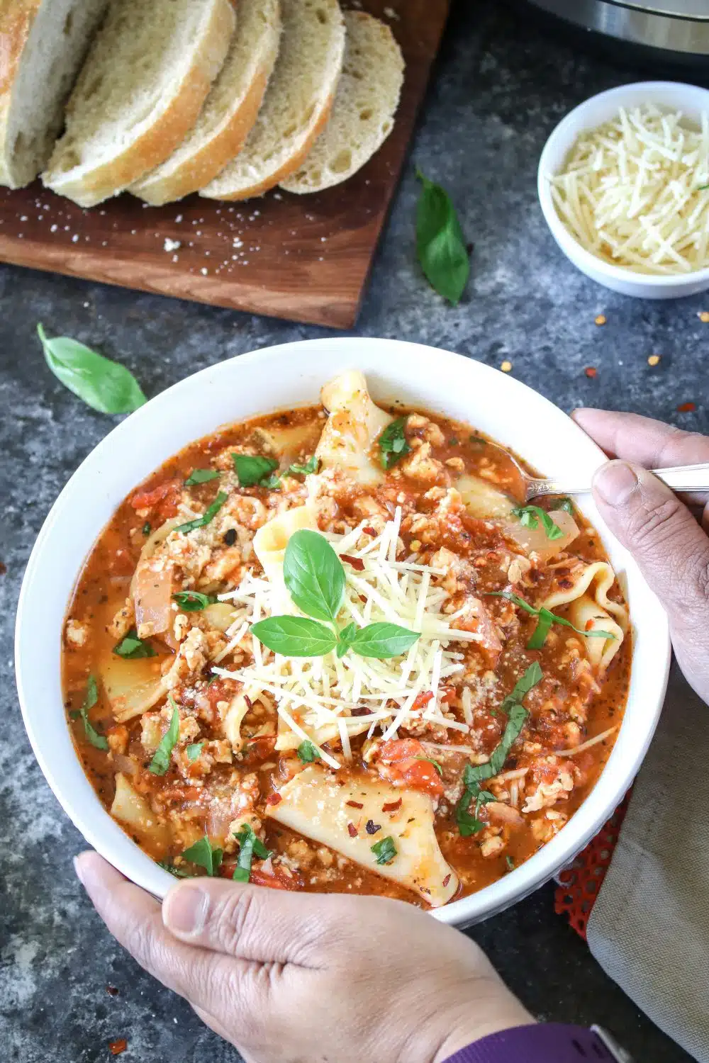 Lasagna soup with bread in background