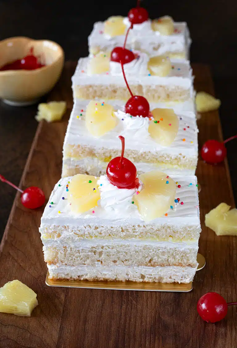 Best eggless pineapple pastry with cherries and sprinkles
