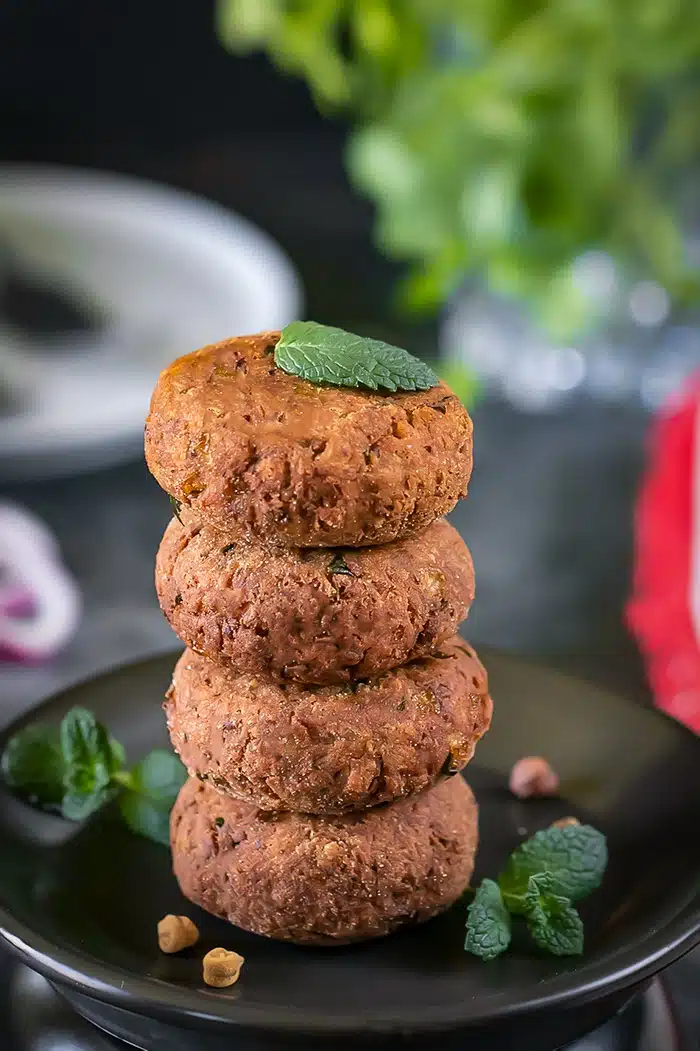 Kala Chana Kabab stacked with mint leaves
