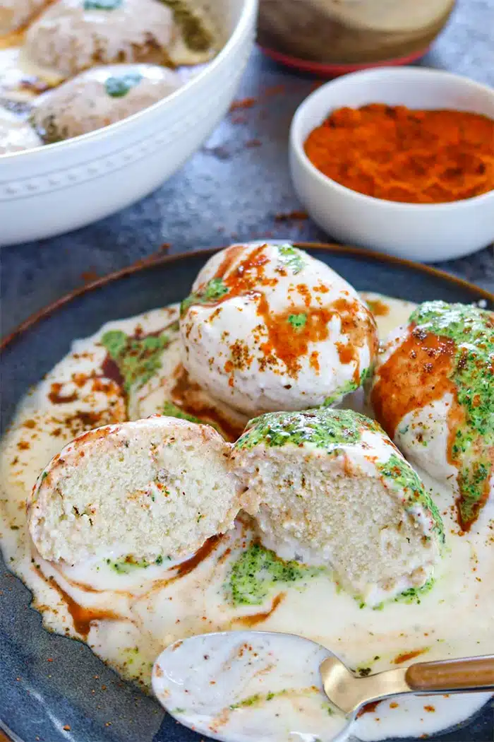 Dahi bhalla on a blue plate with an inside view