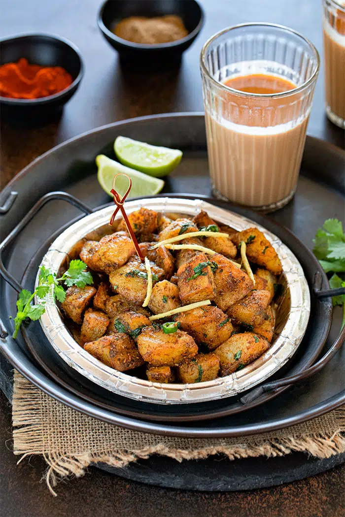 Delhi Aloo Chaat in a plate with lemon wedge